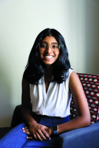 Eunice Stephen smiles while seated in a chair for a portrait.